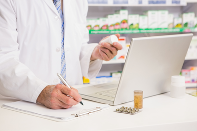 pharmacist writing on clipboard