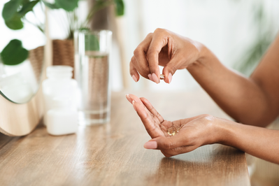 person holding pills in palm